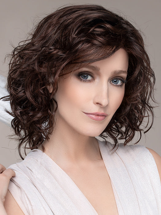 DELICATE PLUS by ELLEN WILLE in DARK CHOCOLATE MIX   This image was styled as follows: Curling iron 350°F with a ¾” barrel size, alternating curling directions. Finished by lightly scrunching hair with a small amount of BeautiMark Velvet Spray Gel